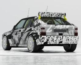 A photograph of the rear quarter of a Lancia Delta Integrale in a custom black and white typographic livery. 